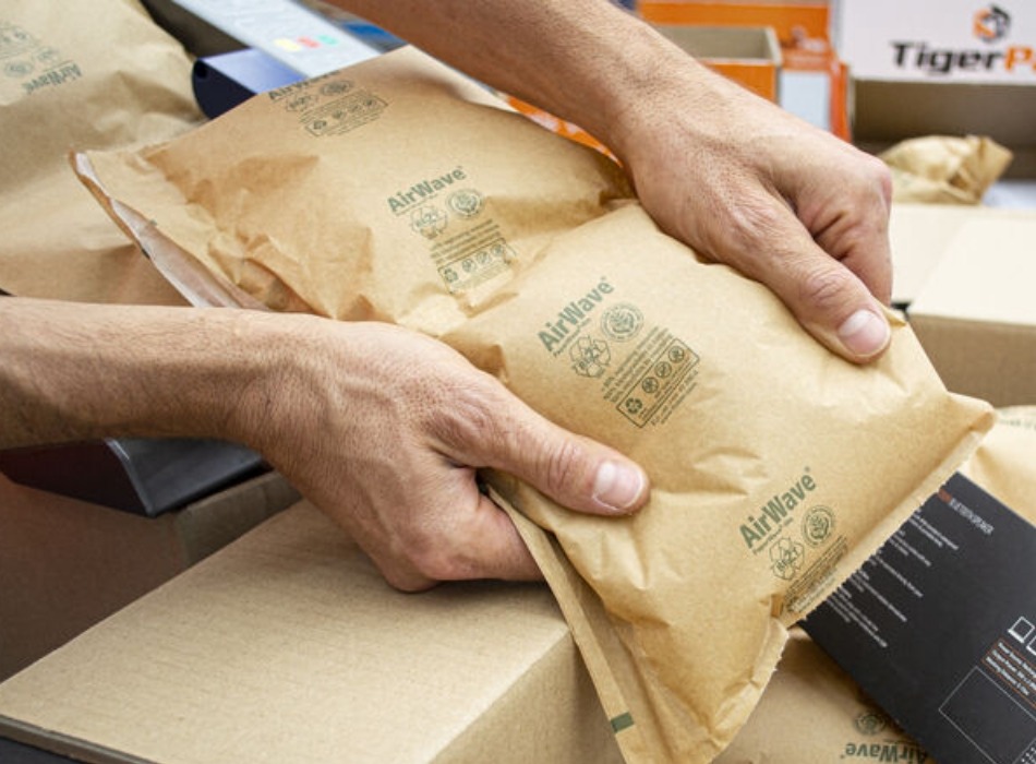 Airwave void fill being put into a corrugate box for protection