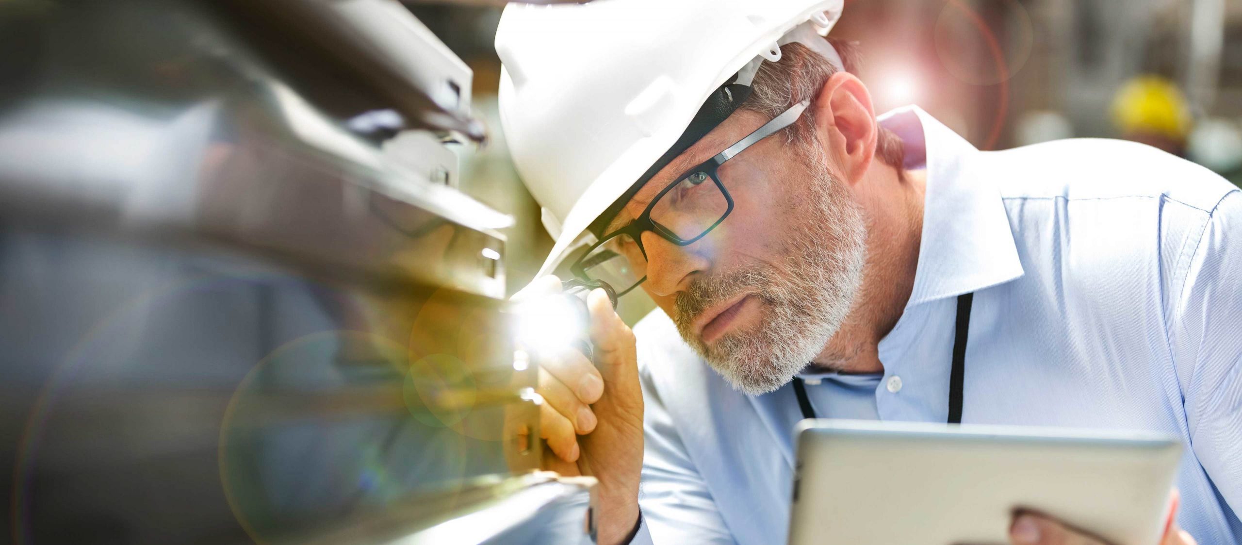 Packaging workflow consultant reviewing operations on a warehouse floor